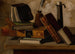 Stillleben mit Büchern, Tintenfass und Kerzenhalter - John Frederick Peto — Ansicht des Kunstwerks